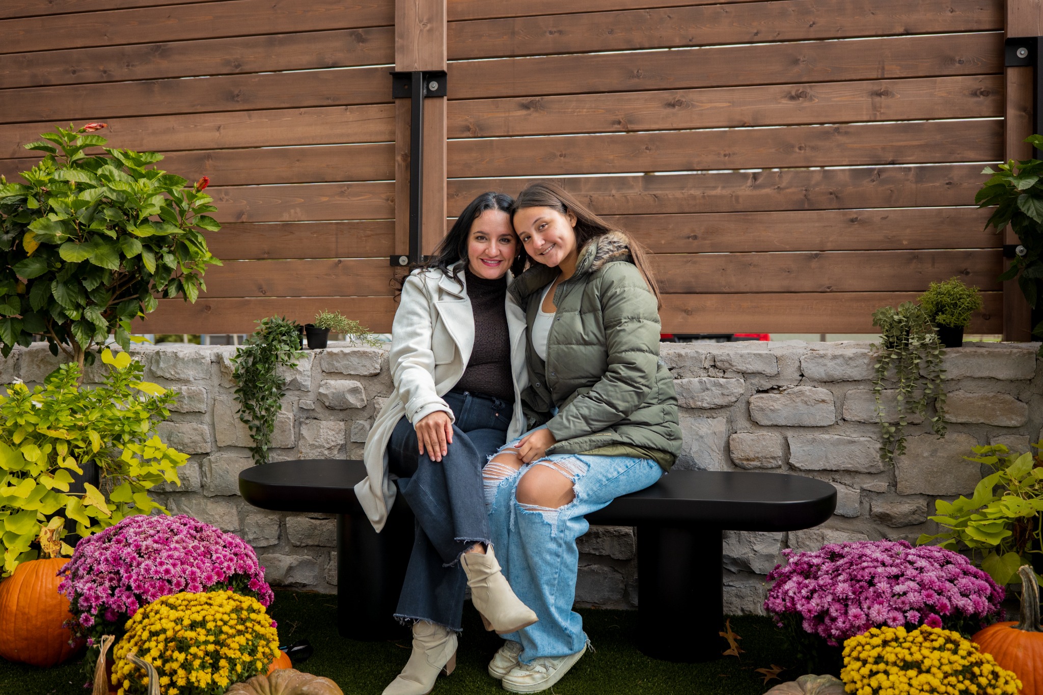 Two clients smiling together for their fall portrait