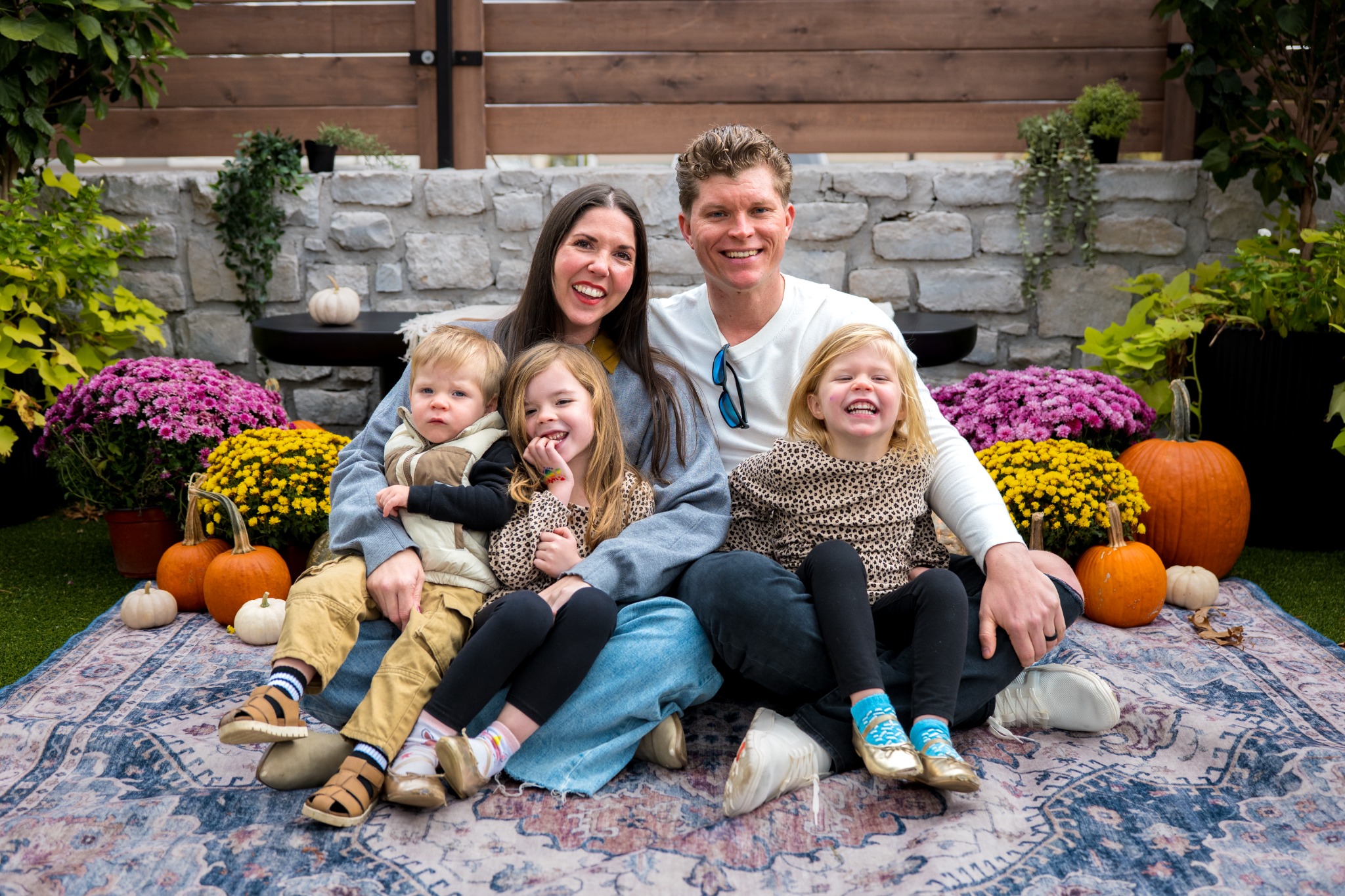 A family sitting together for their fall portrait